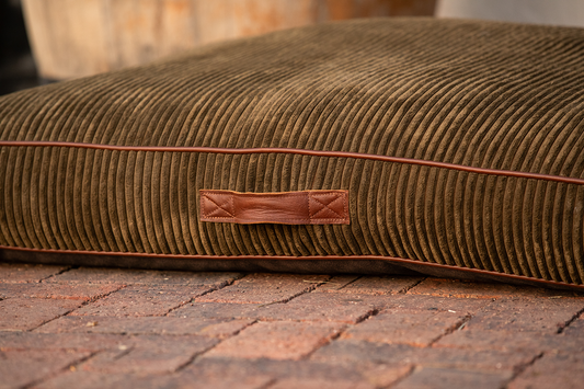 Dog bed - green corduroy with leather piping